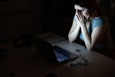 Young woman using laptop at home