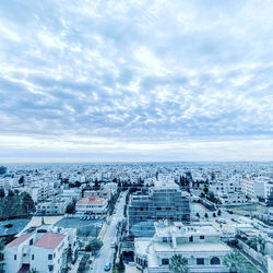 High angle view of city against cloudy sky