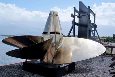 Close-up of ship moored on sea against sky