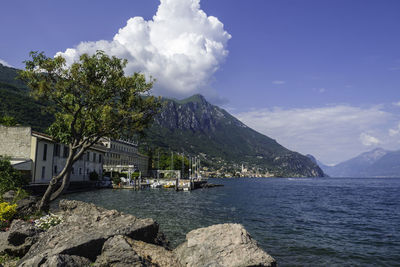 Scenic view of sea by buildings against sky