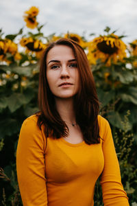 Portrait of a young woman in sunflowers