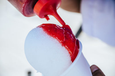 Close-up of hand holding ice cream