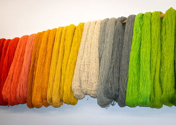 Wool yarn threads, colored yarn skeins on the wall, knitting as a hobby
