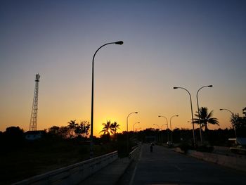 Street against clear sky at sunset