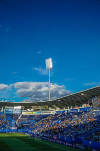 Crowd on the road against blue sky