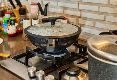 Pots with cooking food in the kitchen on gas stove