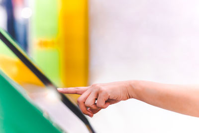 People hand uses digital touch screen to get information.