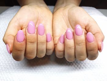 Cropped hands of woman showing her painted fingernails