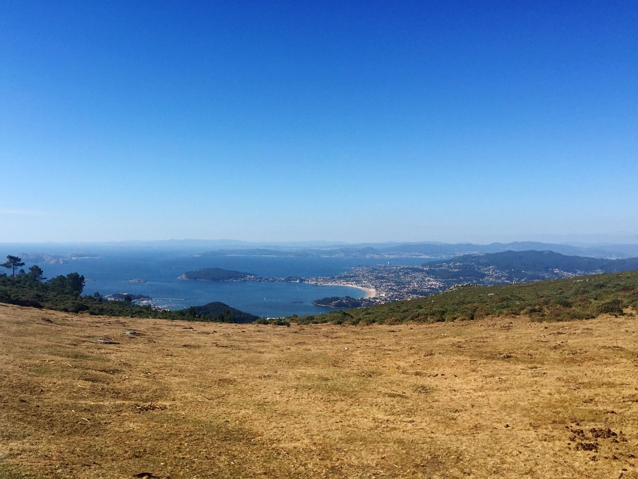 clear sky, blue, tranquil scene, tranquility, water, scenics, beauty in nature, nature, landscape, mountain, idyllic, coastline, day, outdoors, non-urban scene, no people, remote, hill, horizon over land, sky, non urban scene