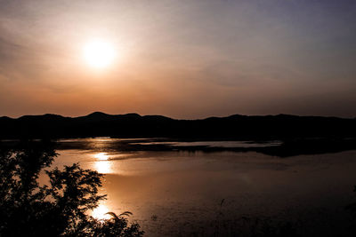 Scenic view of lake against sky during sunset