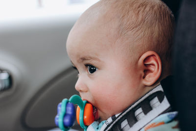 Sweet little baby boy in the car in baby safety seat