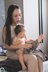Young woman using digital tablet at home