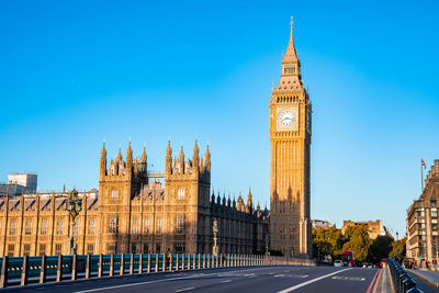 Early empty sunday morning by the big ben clock tower and westminster in london.