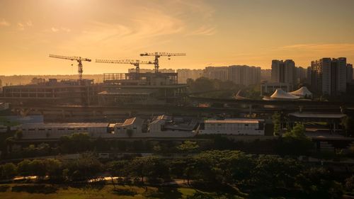 Buildings in city against sky during sunset