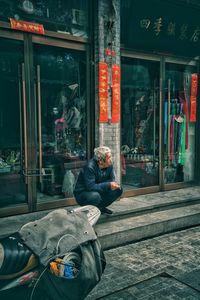 Man sitting by window at store