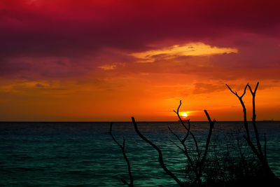 Scenic view of sea against romantic sky at sunset