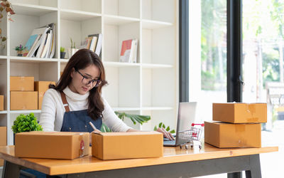 Portrait of smiling young woman working at home