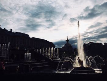 Fountain in city against sky