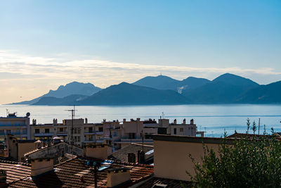 High angle view of bay and buildings against sky