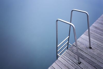 High angle view of ladder leading towards lake