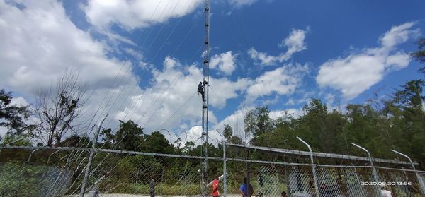 Low angle view of people playing against sky