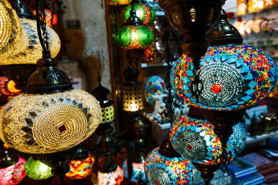 Multi colored lanterns hanging for sale in store