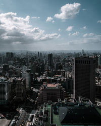 High angle view of modern buildings in city against sky