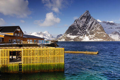 Built structure by sea against sky