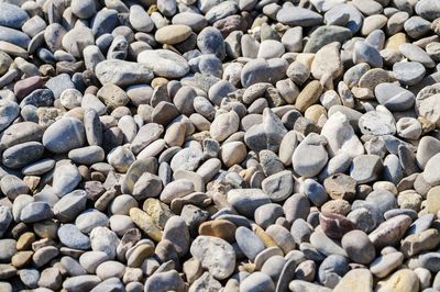 Full frame shot of pebbles on sunny day