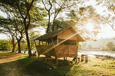 Gazebo on table by trees against sky