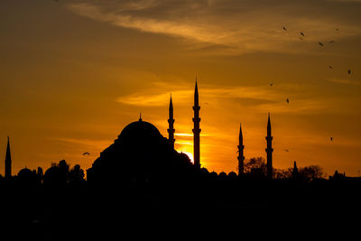 Silhouette of mosque against sky during sunset