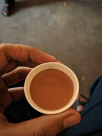 Person holding coffee cup