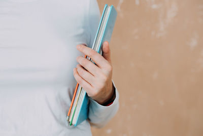 A woman holds books in her hands, selection of books to read and study