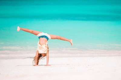 Woman with umbrella on beach