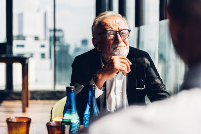 Senior man wearing eyeglasses sitting at office