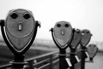 Close-up of coin-operated binoculars against sky