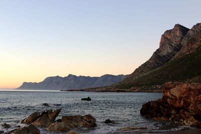 Scenic view of sea against clear sky during sunset