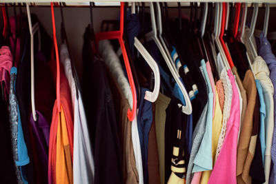 Various clothes hanging in rack at store