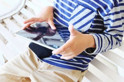 Low section of man using mobile phone at home