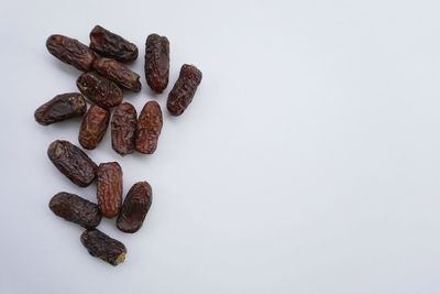 High angle view of coffee beans against white background