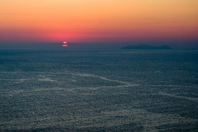 Scenic view of sea against romantic sky at sunset