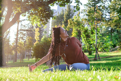 Low section of woman sitting in park