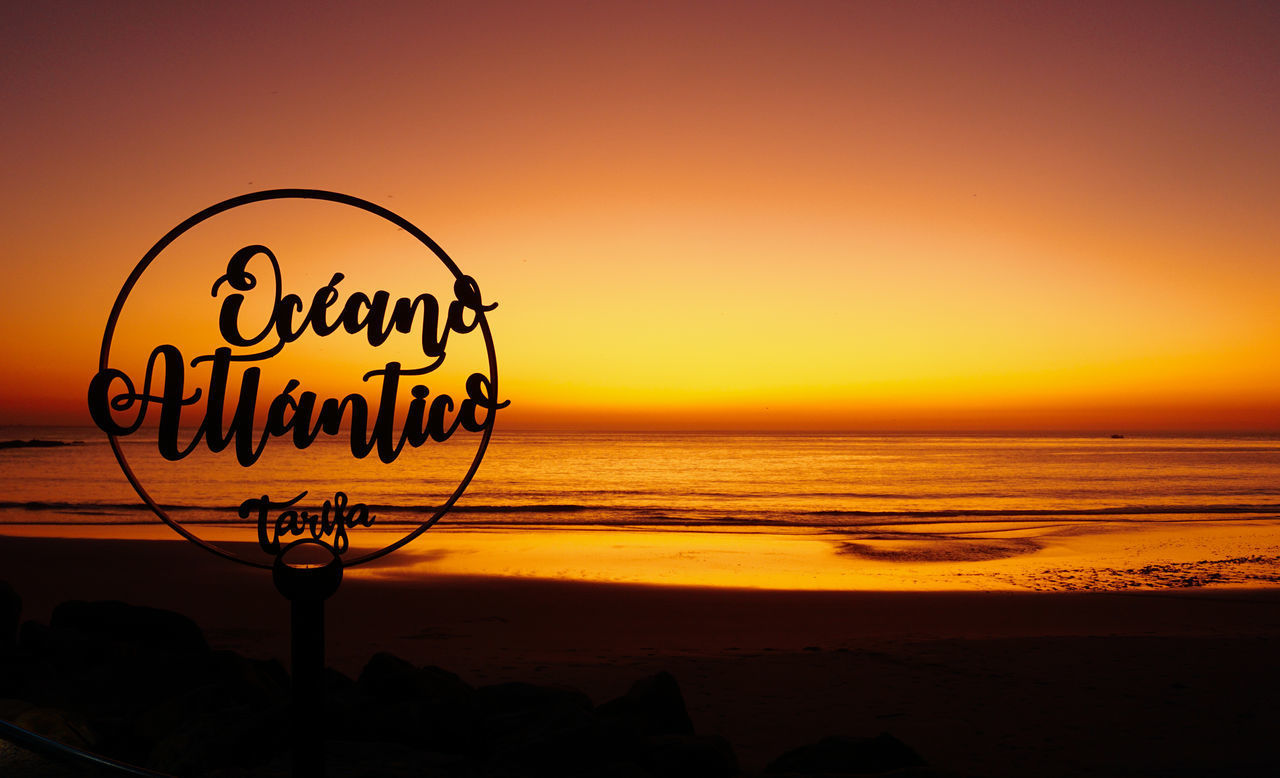 SILHOUETTE TEXT ON BEACH DURING SUNSET