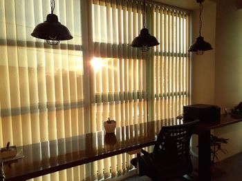 Illuminated electric lamp hanging on table at home