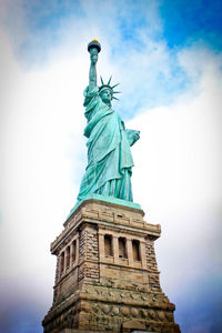 Low angle view of statue against cloudy sky