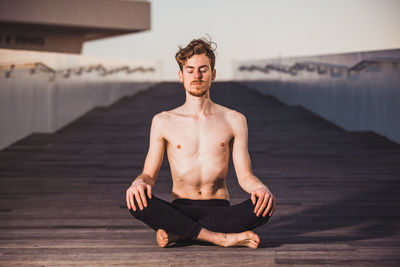 Portrait of young man sitting outdoors