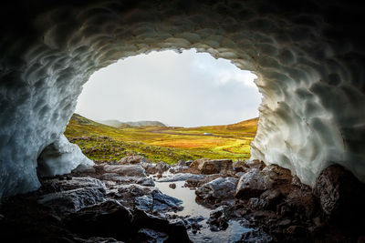 Scenic view of sea seen through arch