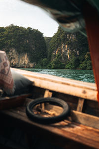 Low section of man sitting on retaining wall