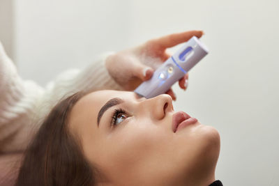 Close-up of young woman using mobile phone