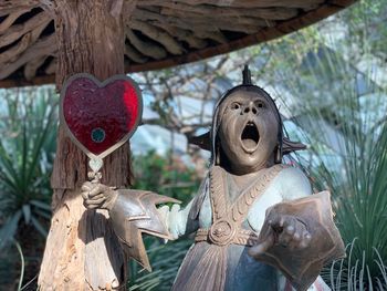 Close-up of statue against trees